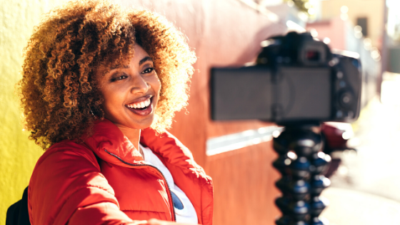 Happy woman vlogging; filming herself